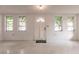 Bright and airy entryway with white walls and terrazzo flooring at 515 W Olympia Ave, Punta Gorda, FL 33950