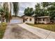 Tan single-story home with attached garage and a long driveway at 515 W Olympia Ave, Punta Gorda, FL 33950