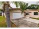 House exterior with a white garage door and driveway at 515 W Olympia Ave, Punta Gorda, FL 33950