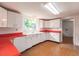 Retro kitchen, white cabinets and red countertops at 515 W Olympia Ave, Punta Gorda, FL 33950