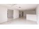 Open concept living area with terrazzo floors and ceiling fan at 515 W Olympia Ave, Punta Gorda, FL 33950