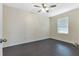 Bright bedroom with wood-look floors and window with blinds at 7081 Crystal Way, Punta Gorda, FL 33950