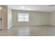 Spacious living room featuring tile floors and large window at 7081 Crystal Way, Punta Gorda, FL 33950