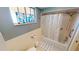 Updated bathroom with shower/tub combo, tile flooring, and stained-glass window at 1 Colony Point Dr # 16C, Punta Gorda, FL 33950