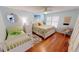 Bright bedroom with hardwood floors, a daybed, and beachy accents at 1 Colony Point Dr # 16C, Punta Gorda, FL 33950