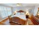 Cozy bedroom with hardwood floors, plantation shutters and coastal decor at 1 Colony Point Dr # 16C, Punta Gorda, FL 33950