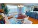 Dining room with hardwood floors, round table, and water views at 1 Colony Point Dr # 16C, Punta Gorda, FL 33950