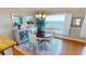 Bright dining area with a round table and large windows offering stunning ocean views at 1 Colony Point Dr # 16C, Punta Gorda, FL 33950