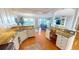 Open-concept kitchen featuring granite countertops, white cabinets, and an ocean view at 1 Colony Point Dr # 16C, Punta Gorda, FL 33950