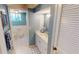 Updated bathroom with white vanity, blue walls, and tile flooring at 1 Colony Point Dr # 16C, Punta Gorda, FL 33950