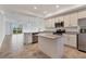 Island kitchen with granite countertops and stainless steel appliances at 14061 Heritage Landing Blvd # 415, Punta Gorda, FL 33955