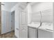 Laundry room with washer, dryer, and shelving at 14061 Heritage Landing Blvd # 415, Punta Gorda, FL 33955