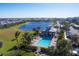 Community pool with lounge chairs and a covered patio area at 14061 Heritage Landing Blvd # 415, Punta Gorda, FL 33955