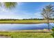 Waterfront view of building with lush landscaping at 14061 Heritage Landing Blvd # 415, Punta Gorda, FL 33955
