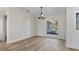 Dining area features light walls, wood-look flooring, and a modern light fixture at 1451 Glenview Rd, North Port, FL 34288