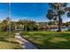 Landscaped backyard with a walkway leading to the waterfront at 17347 Lake Worth Blvd, Port Charlotte, FL 33948