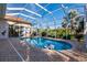 Relaxing pool and patio area with screened enclosure and lush landscaping at 17347 Lake Worth Blvd, Port Charlotte, FL 33948