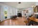 Living room with hardwood floors, large windows, and a vintage piano at 18749 Ackerman Ave, Port Charlotte, FL 33948