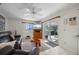 Living room with leather furniture and sliding glass doors at 18749 Ackerman Ave, Port Charlotte, FL 33948