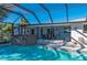 Enclosed pool and spa with patio and canal views at 18749 Ackerman Ave, Port Charlotte, FL 33948