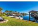 Stunning waterfront view with multiple boat docks and lush landscaping at 18749 Ackerman Ave, Port Charlotte, FL 33948