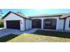 Exterior view of a house with a screened porch and two-car garage at 23155 Adela Ave, Port Charlotte, FL 33952