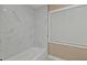 Clean bathroom with a bathtub and marble tile shower surround at 2387 Tamarind St, Port Charlotte, FL 33948