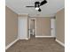 Large bedroom with ceiling fan, private bathroom access, and wood-look floors at 2387 Tamarind St, Port Charlotte, FL 33948
