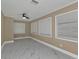 Spacious bedroom with wood-look flooring, ceiling fan, and multiple windows at 2387 Tamarind St, Port Charlotte, FL 33948