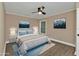 Relaxing bedroom with a ceiling fan, soft natural light, and mountain art on the walls at 2387 Tamarind St, Port Charlotte, FL 33948