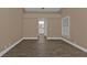 Spacious bedroom with vaulted ceilings, wood-look flooring and an attached bathroom at 2387 Tamarind St, Port Charlotte, FL 33948