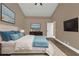 Comfortable bedroom featuring a king-size bed, plush pillows, and a large wall-mounted television at 2387 Tamarind St, Port Charlotte, FL 33948