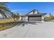 Single-story home with dark garage door at 2387 Tamarind St, Port Charlotte, FL 33948