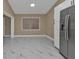 Kitchen with stainless steel refrigerator and marble-look floors at 2387 Tamarind St, Port Charlotte, FL 33948