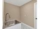 Updated laundry room with stainless steel sink and faucet at 2387 Tamarind St, Port Charlotte, FL 33948