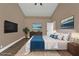 Spacious main bedroom features a king bed, a wall-mounted TV, and complementary wall art at 2387 Tamarind St, Port Charlotte, FL 33948