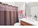 Cozy bathroom with sink and shower with decorative brown and pink curtain at 2481 Daisy Dr, North Port, FL 34289