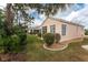 Back exterior of house with screened lanai and landscaped yard at 26138 Stillwater Circle, Punta Gorda, FL 33955