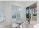 Kitchen nook features a glass table, white wicker chairs, and access to a patio at 26138 Stillwater Circle, Punta Gorda, FL 33955