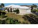 Aerial view of a house with a white roof and landscaped yard at 26159 Stillwater Cir, Punta Gorda, FL 33955