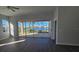 Living room with lake view and sliding glass doors at 26159 Stillwater Cir, Punta Gorda, FL 33955