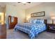 Main bedroom with king bed, ample natural light, and view of backyard at 2617 Cottonwood Ln, North Port, FL 34289