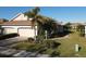 Single-story house with 2-car garage, palm trees, and well-manicured lawn at 2617 Cottonwood Ln, North Port, FL 34289