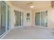 Spacious back patio with sliding glass doors and ceiling fan at 267 Lecturn St, Port Charlotte, FL 33954