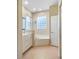 Bathroom with double vanity, soaking tub, and a glass block window at 267 Lecturn St, Port Charlotte, FL 33954