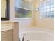 Relaxing bathroom with a large soaking tub and a window at 267 Lecturn St, Port Charlotte, FL 33954