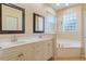 Spa-like bathroom with double vanity, soaking tub, and large mirrors at 267 Lecturn St, Port Charlotte, FL 33954