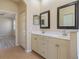 Double vanity bathroom with two sinks and large mirrors at 267 Lecturn St, Port Charlotte, FL 33954