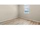 Simple bedroom with wood-look floors and window at 267 Lecturn St, Port Charlotte, FL 33954