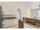 Bright kitchen features granite countertops, stainless steel appliances, and white cabinets at 267 Lecturn St, Port Charlotte, FL 33954